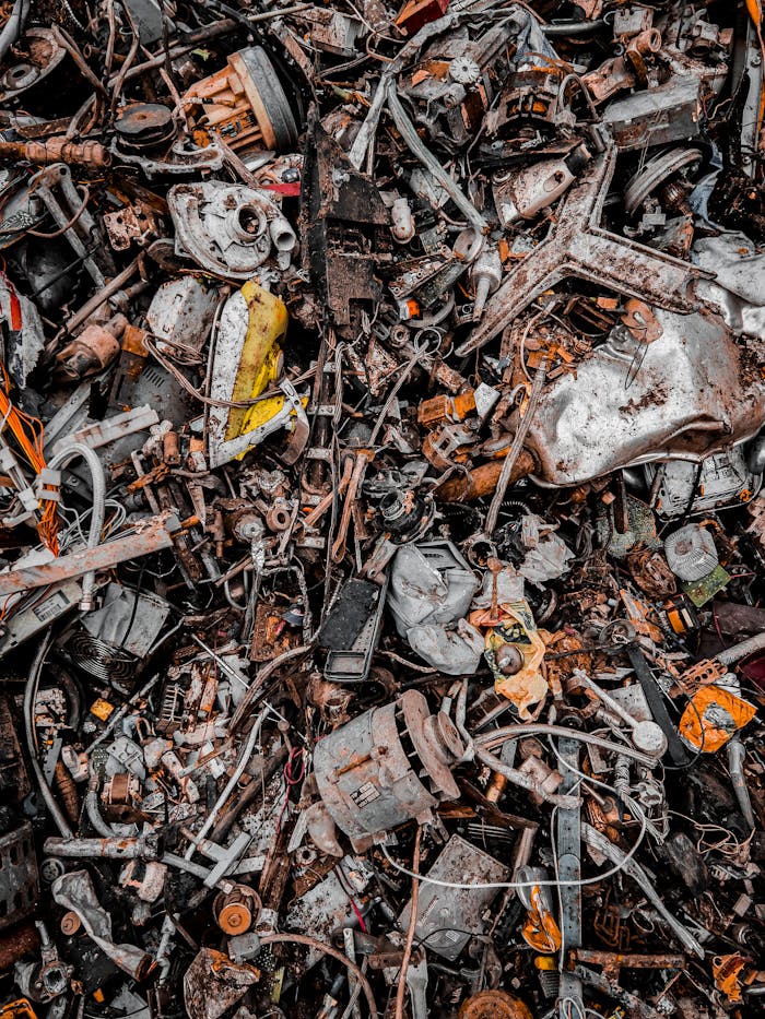 pile-of-garbage-10783800 A chaotic pile of metal scrap and waste, showcasing decaying and rusty components in an industrial setting.